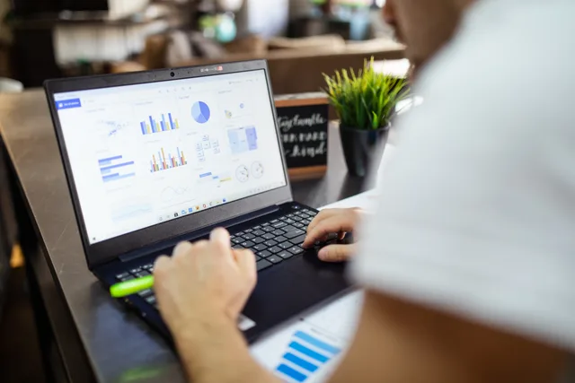 Focused business analysis with charts and graphs on a laptop in a modern office setting. Why a shopping feeds ninety day plan beats ad hoc tweaks